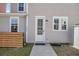Home exterior with a white front door, tidy landscaping, and light-colored siding at 4603 Scout Aly, North Charleston, SC 29405