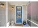 Welcoming front porch with a vibrant blue door, decorative lantern, and charming decor at 4603 Scout Aly, North Charleston, SC 29405