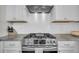 Close-up of a stainless steel gas range with white subway tile backsplash and white cabinetry at 4603 Scout Aly, North Charleston, SC 29405