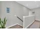 Upstairs hallway featuring gray walls, decorative plant, and wooden handrail staircase at 4603 Scout Aly, North Charleston, SC 29405