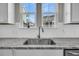 Kitchen sink with stainless steel faucet, granite countertop, and view of the neighborhood outside at 4603 Scout Aly, North Charleston, SC 29405
