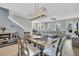 Open-concept living and dining area featuring wood floors, stylish chandelier, and comfortable neutral-toned furniture at 4603 Scout Aly, North Charleston, SC 29405