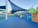 Colorful playground with slides, bridges, and climbing structures with blue ground at 4603 Scout Aly, North Charleston, SC 29405