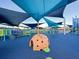 Fun playground featuring a covered climbing structure and varied activities, shaded by large blue canopies at 4603 Scout Aly, North Charleston, SC 29405