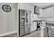 Stainless steel refrigerator in a well-lit kitchen with white cabinetry and subway tile backsplash at 4603 Scout Aly, North Charleston, SC 29405