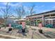 Outdoor seating at a modern restaurant featuring colorful picnic tables and shade umbrellas at 4603 Scout Aly, North Charleston, SC 29405