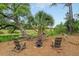 Serene backyard setting with two wooden chairs and a fire pit at 4874 Sound View Dr, Mount Pleasant, SC 29466