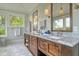 Bathroom features dual vanities, wood cabinetry, marble countertops, and scenic views at 4874 Sound View Dr, Mount Pleasant, SC 29466