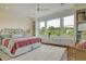 Bright bedroom featuring large windows, a cozy rug, and stylish decor, creating a comfortable and inviting space at 4874 Sound View Dr, Mount Pleasant, SC 29466
