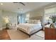 Bright bedroom featuring a tufted headboard, wood floors, and tranquil natural light at 4874 Sound View Dr, Mount Pleasant, SC 29466