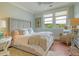 Cozy bedroom features a plush bed, a window view, and a comfortable sitting area with charming decor at 4874 Sound View Dr, Mount Pleasant, SC 29466