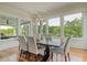 Bright dining room with large windows, modern chandelier, and hardwood floors at 4874 Sound View Dr, Mount Pleasant, SC 29466