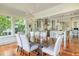 Elegant dining room with large windows, hardwood floors, and views into the beautifully designed kitchen at 4874 Sound View Dr, Mount Pleasant, SC 29466