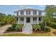 Stunning two-story home with inviting porch, well-manicured lawn, and lush landscaping at 4874 Sound View Dr, Mount Pleasant, SC 29466