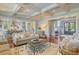 Bright, airy living room featuring coffered ceilings, hardwood floors, and seamless flow into the adjacent kitchen at 4874 Sound View Dr, Mount Pleasant, SC 29466