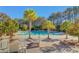 Beautiful swimming pool surrounded by palm trees and lush greenery, creating a tropical oasis at 4874 Sound View Dr, Mount Pleasant, SC 29466