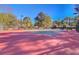 Well-maintained tennis court surrounded by trees and fencing, offering a private sporting experience at 4874 Sound View Dr, Mount Pleasant, SC 29466