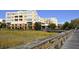 Yellow condo building exterior featuring balconies and a wooden walkway at 5009 Old Bridgeview Ln # 5009, Charleston, SC 29403