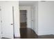 Hallway with dark hardwood floors, white walls, white doors and trim, and access to walk-in closet at 5009 Old Bridgeview Ln # 5009, Charleston, SC 29403