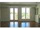 Living area featuring hardwood floors, balcony access, a fireplace, and built-in cabinets at 5009 Old Bridgeview Ln # 5009, Charleston, SC 29403