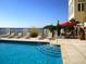 Inviting outdoor pool area with lounge chairs and umbrellas, perfect for relaxation by the waterfront at 5009 Old Bridgeview Ln # 5009, Charleston, SC 29403
