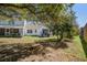Backyard showing a large tree, patio, and wood fence at 507 Tayrn Dr, Charleston, SC 29492