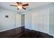 A spacious bedroom with a ceiling fan, closet, and dark wood floors at 507 Tayrn Dr, Charleston, SC 29492