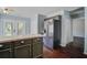 Stylish kitchen with stainless steel refrigerator, dark cabinets, and hardwood floors at 507 Tayrn Dr, Charleston, SC 29492