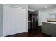Bright kitchen features stainless steel refrigerator, dark cabinetry, and sleek hardwood floors at 507 Tayrn Dr, Charleston, SC 29492