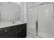 A full bathroom with a glass shower and dark vanity with modern hardware at 5108 Celtic Dr, North Charleston, SC 29405