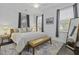A well-lit bedroom with a wooden bed frame, bench, and a stylish area rug at 5108 Celtic Dr, North Charleston, SC 29405