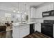 Open-concept kitchen and living space with an eat-in island and stainless appliances at 5108 Celtic Dr, North Charleston, SC 29405