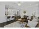 Bright and airy living room with dark wood floors, a modern fan, and comfortable leather seating at 5108 Celtic Dr, North Charleston, SC 29405