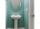 Bathroom features a modern pedestal sink, oval mirror, and aqua colored walls at 529 Pleasant Side Dr, Moncks Corner, SC 29461