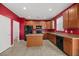 Eat-in kitchen featuring oak cabinets, black appliances, tile flooring, and access to laundry room at 529 Pleasant Side Dr, Moncks Corner, SC 29461