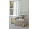 Sitting Area next to a window featuring a cream colored accent chair and side table at 5573 Ruby Falls Drive Ln, North Charleston, SC 29420