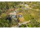 Aerial view of a home nestled in a wooded area, highlighting the property's location and surrounding landscape at 671 Riley Rd, Charleston, SC 29412