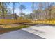 The home has a large, grassy backyard with concrete patio, wood fence and mature trees at 671 Riley Rd, Charleston, SC 29412
