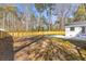 Large, grassy backyard with wood fence, concrete patio, and new white exterior at 671 Riley Rd, Charleston, SC 29412