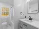 Bright bathroom with a white vanity, quartz countertop, framed mirror, and a window to the outdoors at 671 Riley Rd, Charleston, SC 29412