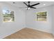 Bright bedroom featuring recessed lighting, ceiling fan and wood-look flooring, with views from two windows at 671 Riley Rd, Charleston, SC 29412