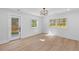 Bright bedroom with wood floors, white shiplap accent wall, and access to outdoor patio at 671 Riley Rd, Charleston, SC 29412