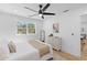 Cozy bedroom with shiplap accent wall, light wood floors, and white furniture, offering serene retreat at 671 Riley Rd, Charleston, SC 29412
