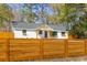 Beautifully renovated home featuring a privacy fence and a manicured front yard at 671 Riley Rd, Charleston, SC 29412