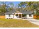 Charming renovated single-story home with a painted brick exterior and inviting front porch at 671 Riley Rd, Charleston, SC 29412