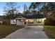 Attractive single-Gathering home boasting a fresh white brick finish, dark roof, and ample parking space at 671 Riley Rd, Charleston, SC 29412