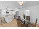 Modern kitchen with white cabinets, stainless steel appliances, and an adjoining dining area at 671 Riley Rd, Charleston, SC 29412