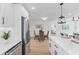 Bright kitchen open to dining area with stainless steel appliances and light wood floors at 671 Riley Rd, Charleston, SC 29412