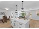 Open concept living space featuring a kitchen with a waterfall island and a bright living room at 671 Riley Rd, Charleston, SC 29412