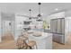 Bright kitchen features a waterfall island with seating, stainless steel appliances, and modern pendant lighting at 671 Riley Rd, Charleston, SC 29412